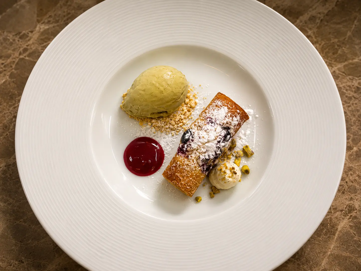 Plated dessert with gelato and pastry