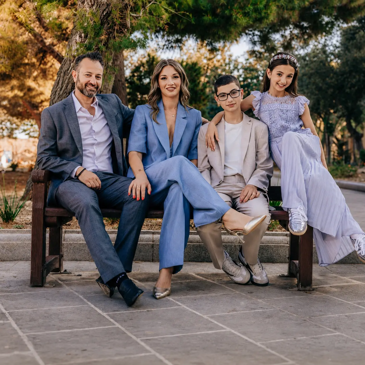 Malcolm, Sherrie and their two children on a bench in Valletta