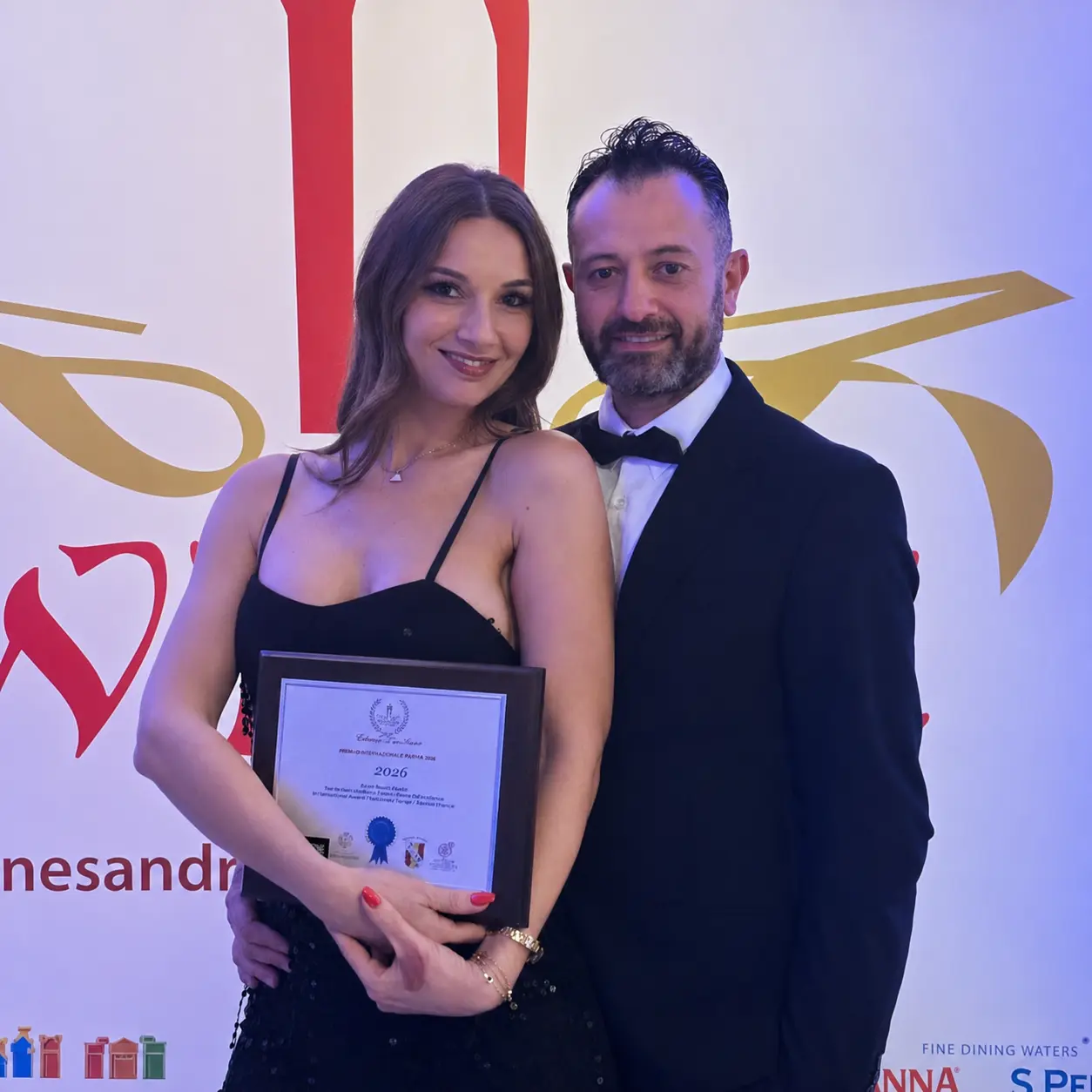 Sherrie and Malcolm with an international award plaque