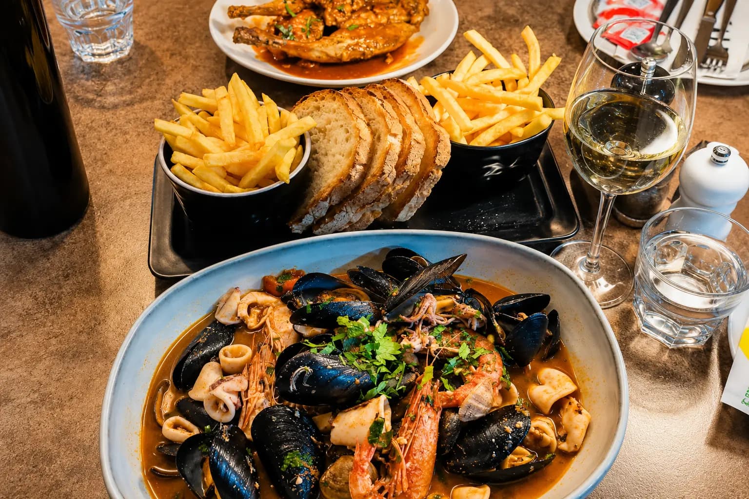 Seafood stew with mussels, prawns and fries
