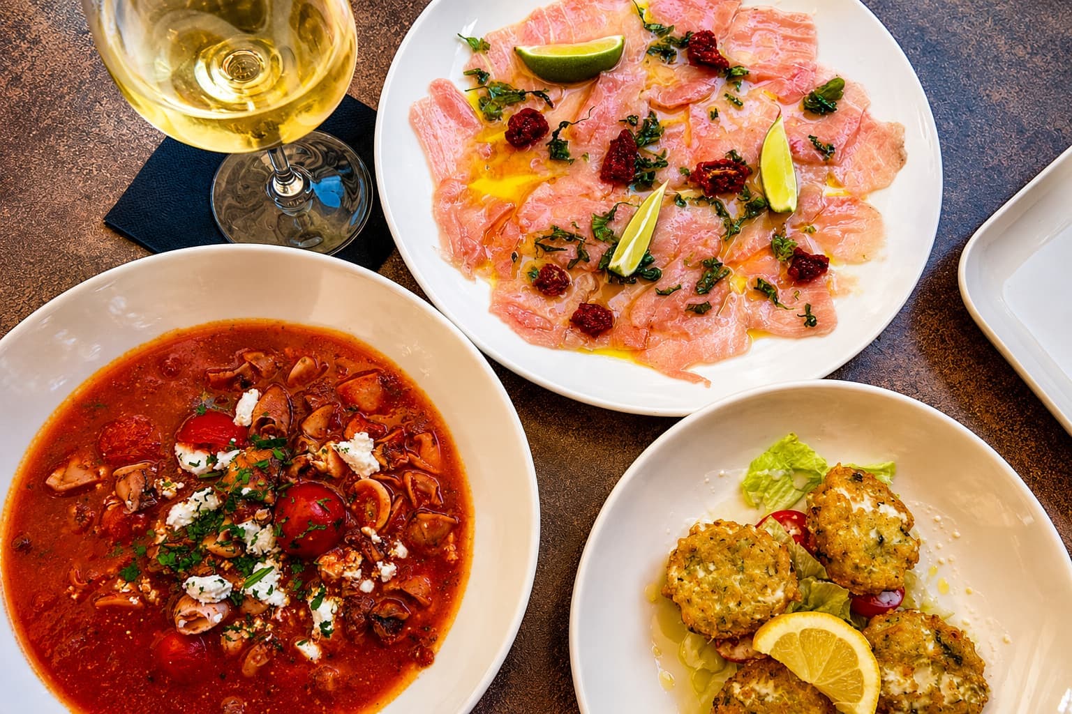 A spread of sharing dishes and carpaccio